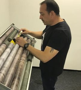 An example of a geologist analysing a core sample at base. Note with ease due to the fluid access to the core sample held within the core tray.