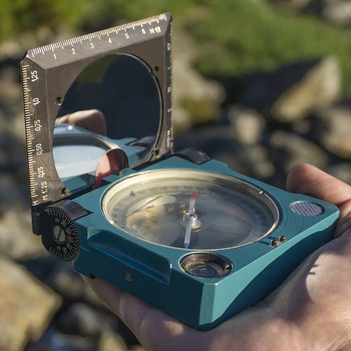 Geological compass open to the sighting position in order to take directional readings for strike and dip.