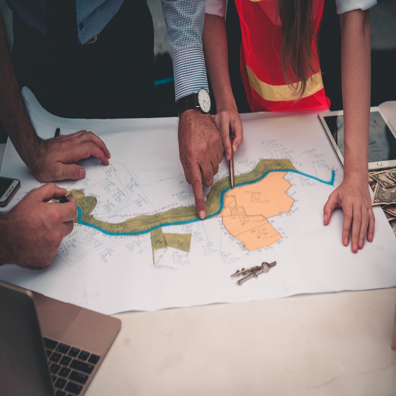 High Angle View Of Mineral Exploration Geologists during the field study planning stage of a project.