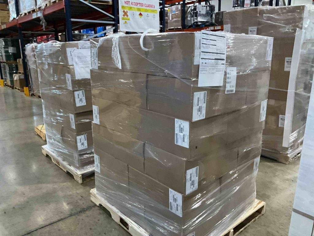 3 pallets of 20 compartment rock chip trays for a mineral exploration drilling project after shrink wrapping. Before being dispatched via airfreight to Mauritania.